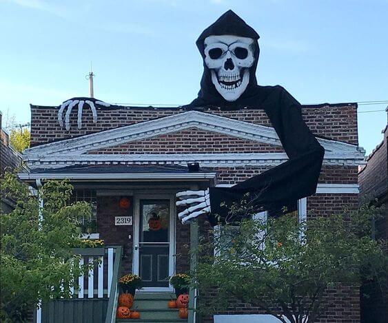 Big Scary Skull Wearing mask Holding House under his hand